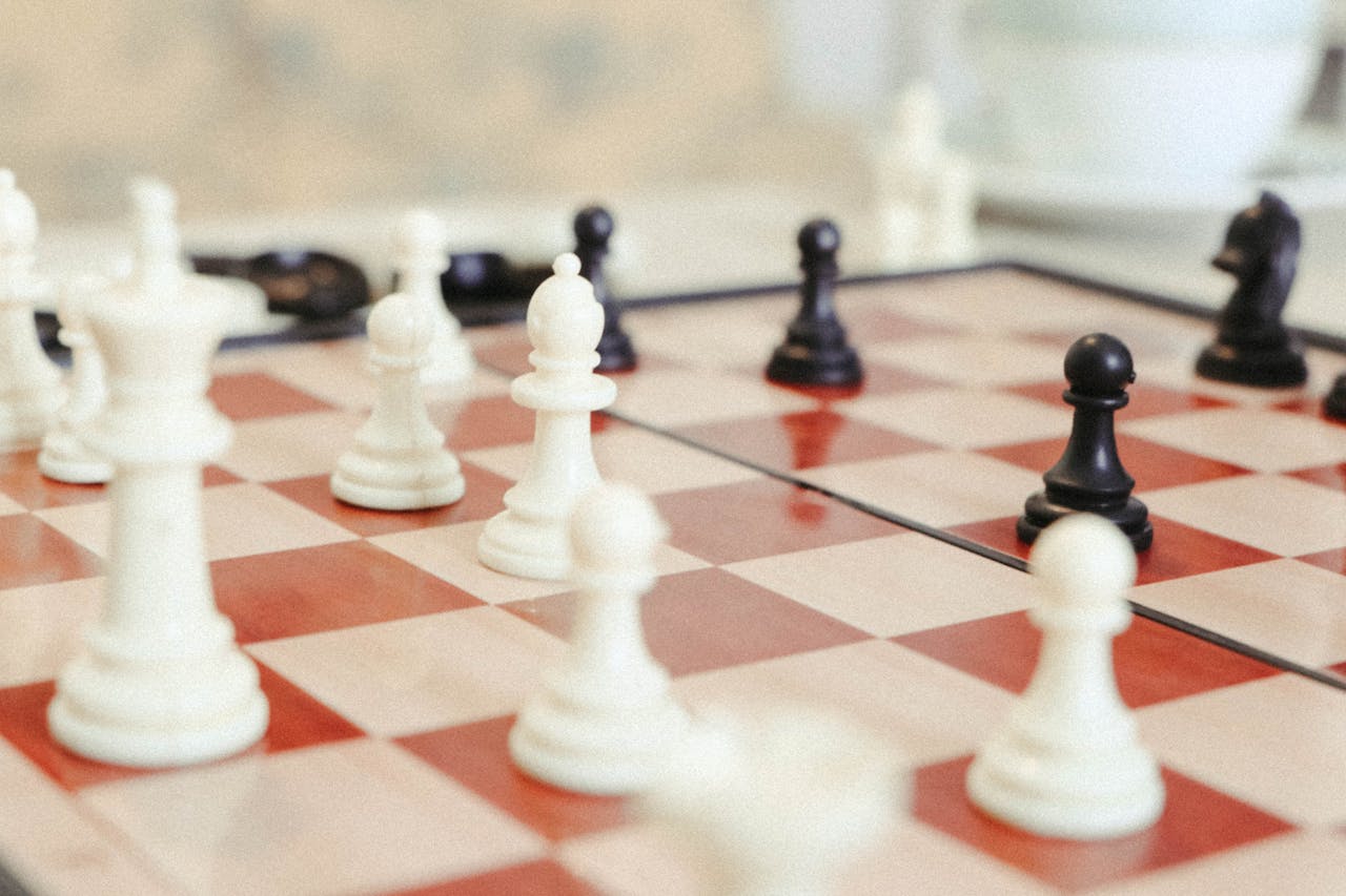 hero-img-02 A detailed close-up of a chess game in progress with focus on the pieces.